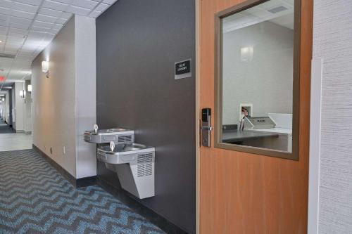 a bathroom with two sinks and a mirror at Sleep Inn & Suites Washington near Peoria in Washington