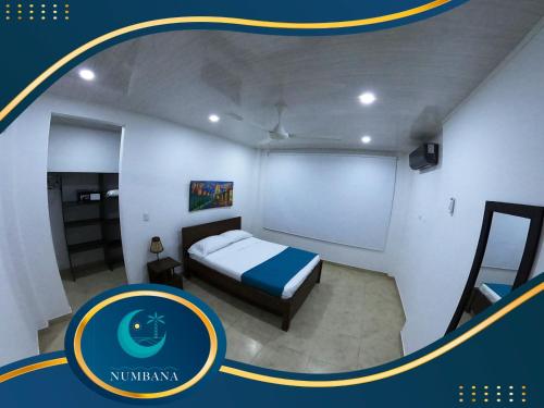 a small bedroom with a bed in a room at Villa Campestre Numbana Melgar in Melgar