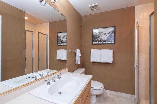 a bathroom with a sink and a toilet at Cozy Condo steps to Coonskin lift in Telluride