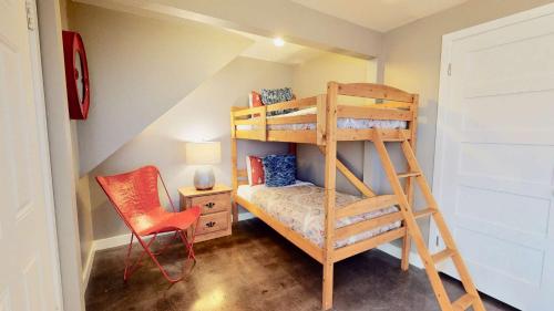 a bedroom with a ladder bunk bed and a chair at Downtown Cozy Home Base - Purple Sage 2 in Moab