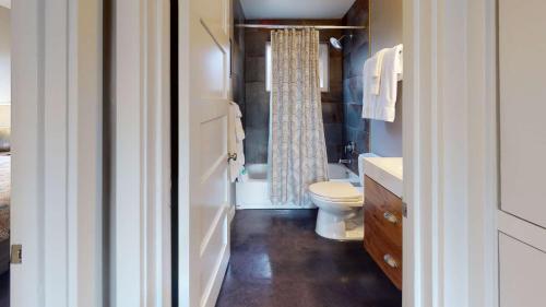 a bathroom with a toilet and a sink at Downtown Cozy Home Base - Purple Sage 2 in Moab