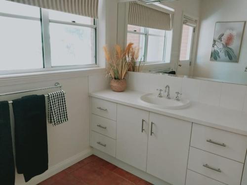 a bathroom with a sink and a mirror at Downing Estate Homestead in Heathcote