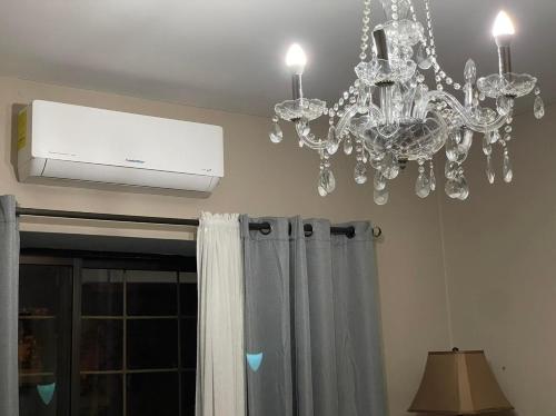 a chandelier and a air conditioner in a room at Quinta Vela Hotel in Tegucigalpa