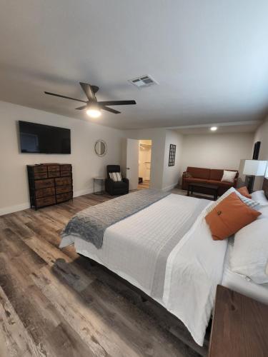 a bedroom with a large bed with a ceiling fan at Pampas House in Las Vegas