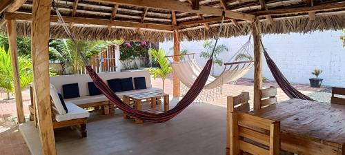 a patio with hammocks and a table and chairs at Casa Veranera Beach in Hacienda San Clemente