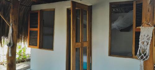 two windows and a door on a house at Sonar del Viento in San Bernardo del Viento