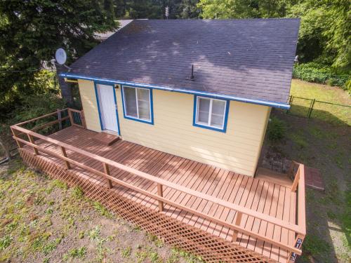 a house with a wooden deck in front of it at Lees Place in Neotsu