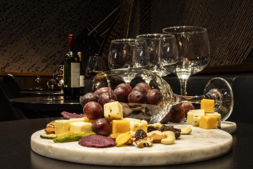 a plate of cheese and grapes and wine glasses at Carnegie Hotel in New York