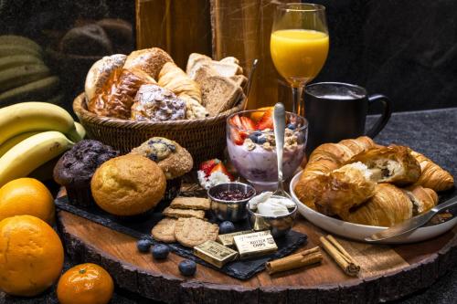 a table with a bunch of different types of bread and orange juice at Carnegie Hotel in New York
