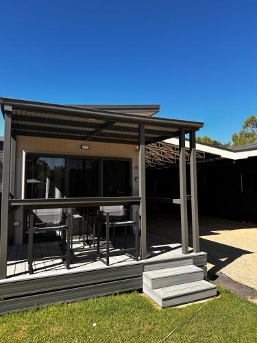 a gazebo with chairs and tables in a yard at Bundalong Villas in Bundalong
