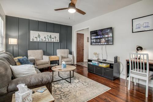 a living room with a couch and a table at Chic Home with Huge Grassy Yard 7 mins to Arrowhead Stadium in Independence