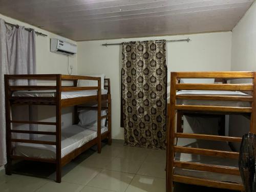 a room with two bunk beds and a window at Pearson Street in Freetown