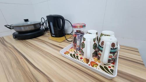 a table with a tray of food on a counter at Pixie Homestay at The Heights Residence Ayer Keroh Melaka in Ayer Keroh