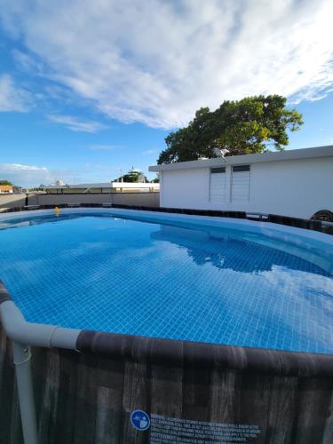 a large swimming pool on top of a building at Black and white vacation home in Ceiba