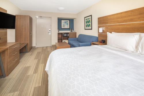 a hotel room with a large bed and a couch at Holiday Inn Express San Diego Airport-Old Town by IHG in San Diego