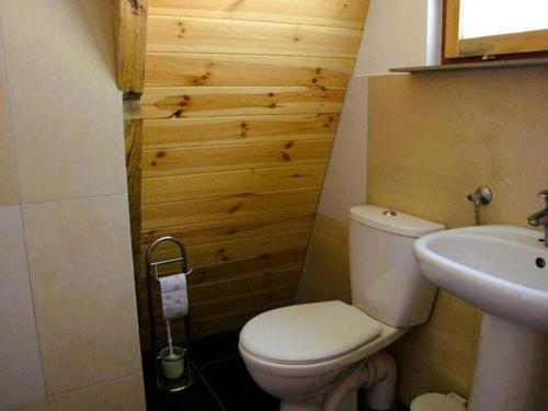 a bathroom with a white toilet and a sink at Summer house for 4 people, close to the sea in Łazy