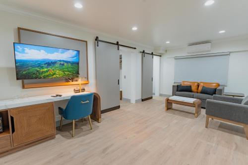 a living room with a tv on a wall at Avanti in Santa Maria
