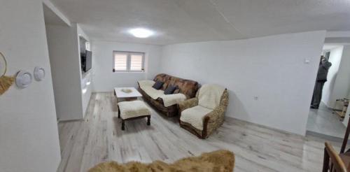 a living room with a couch and two chairs at The Uptown in Strumica