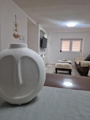 a living room with a white vase on the floor at The Uptown in Strumica