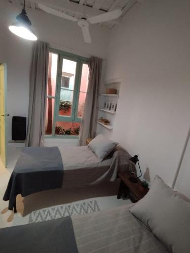 a bedroom with a large bed and a window at CasaLins in Chascomús