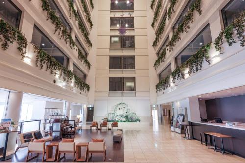 a lobby of a building with chairs and tables at Bayside Hotel Azur Takeshiba in Tokyo