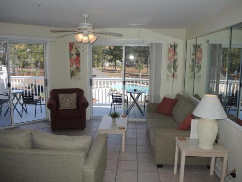 a living room with a couch and a table at Golf Resort Villa 2607 with Outdoor Pool in Calabash
