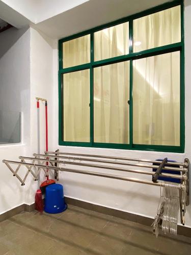 a bathroom with a large window and a blue bucket at Seanest Residence 贤巢民宿 18 "Owned by Amadel Residence" in Melaka