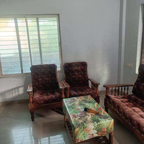 a living room with two chairs and a table at Deep Apartment 