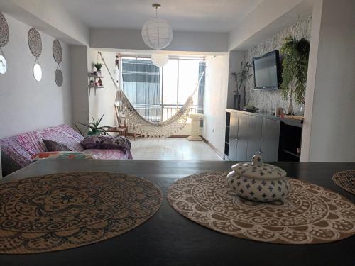 a living room with a table with a vase on it at Las orquideas in Caraballeda