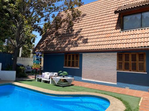 a house with a swimming pool in the yard at MAKTVB Costanera - Hostal Boutique in Santiago