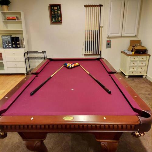 a pool table with two cuesticks on top of it at Exquisite 1 Bedroom, 1 Full Bath Apartment in Upper Marlboro