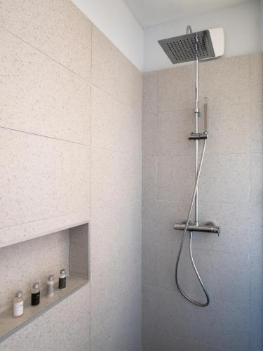 a shower with a shower head in a bathroom at Le Tahiti by Pearl Resorts in Papeete