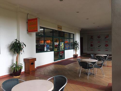 a dining room with tables and chairs in a restaurant at Seanest Residence 贤巢民宿 18 "Owned by Amadel Residence" in Melaka
