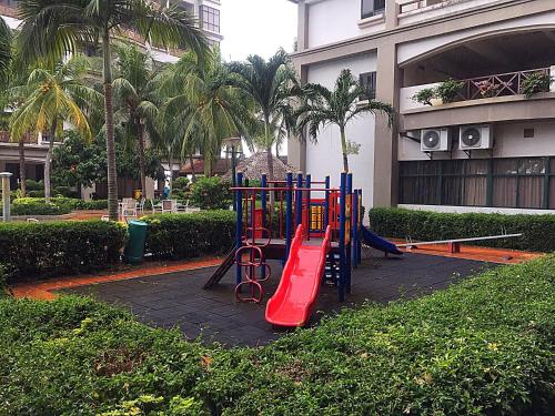 a playground in front of a building with palm trees at Seanest Residence 贤巢民宿 18 "Owned by Amadel Residence" in Melaka