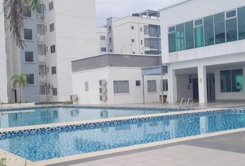 a swimming pool in front of a building at Ipoh - Apartment Casa Klebang 1 Fully Air-Con Suite in Chemor