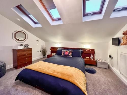 a bedroom with a large bed and skylights at Rosie Cottage in Fowey