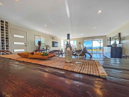 a room with a table with a bottle of wine at Elouera Retreat in Mount View