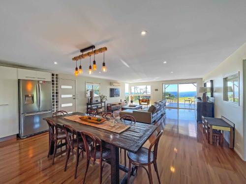 a kitchen and dining room with a table and chairs at Elouera Retreat in Mount View