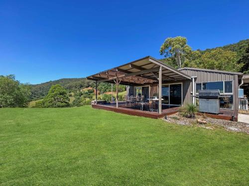 a house with a roof with a grass yard at Elouera Retreat in Mount View