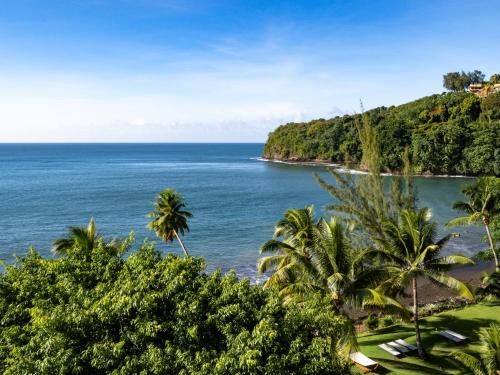 a view of a beach with palm trees and the ocean at Le Tahiti by Pearl Resorts in Papeete