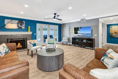 a living room filled with furniture and a fireplace at Huntington Beach, AC, Pool, Hot Tub, Detached Office, Close to Beach, Outside Entertaining Area in Huntington Beach