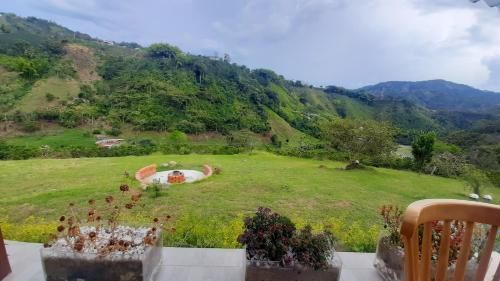 a view of a field with a view of a mountain at AZAHARES HOTEL Y CAFÉ in Manizales