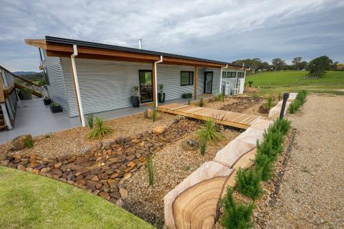 a house with a pathway leading to a yard at The Overflow Blue Mountains in Kanimbla