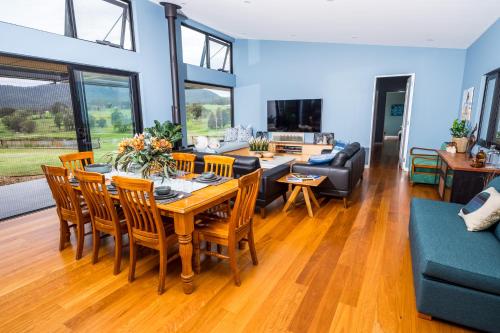 a living room with a table and chairs at The Overflow Blue Mountains in Kanimbla