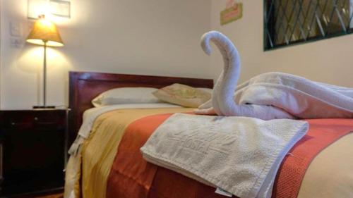 a swan is sitting on top of a bed at La Rosario Hotel in Quito