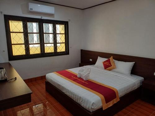 Cama o camas de una habitación en VangVieng Charming Boutique Hotel