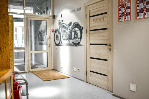 a room with a door with a picture of a motorcycle on the wall at Hostel Forum in Astana