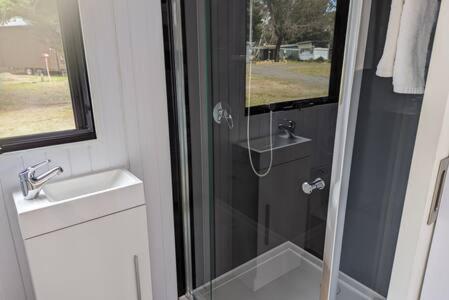a bathroom with a shower and a sink at Tiny House 18 at Grampians Edge in Dadswells Bridge