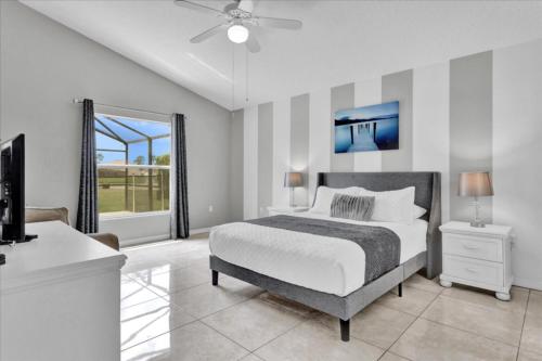 a bedroom with a bed and a large window at 3 Bedrooms - 2 Bathrooms - Cumbrian Lakes 4695 Cl in Orlando