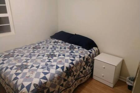 a small bedroom with a bed and a night stand at Kingston Station - 4 in Kingston